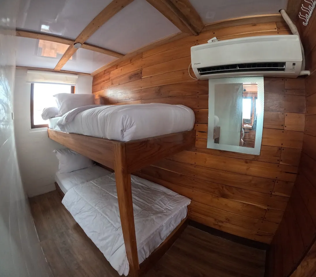 Captain Cabin, a bunk-bed cabin with porthole view aboard the Lombok phinisi