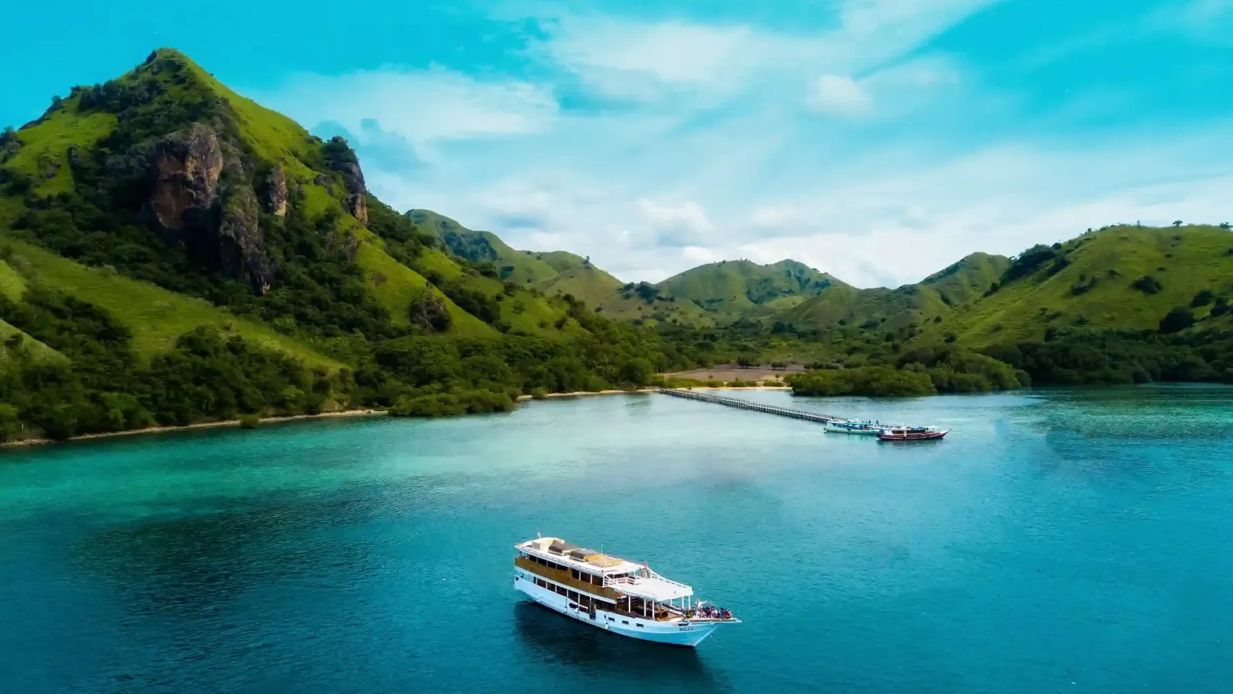 Shallow turquoise water beside a small island